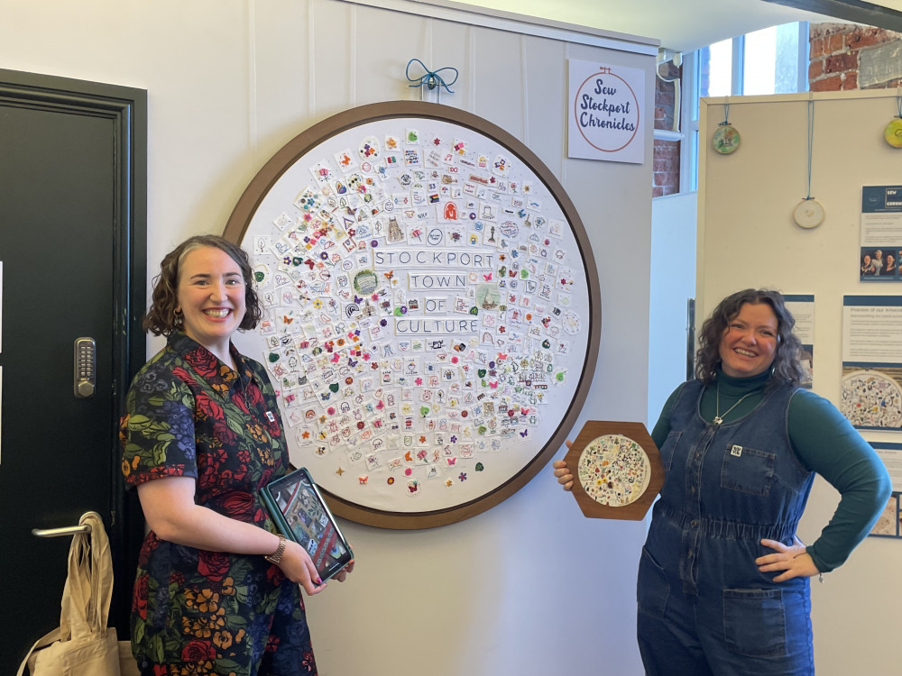 The finished 'Sew Stockport Chronicles' artwork was unveiled in a special ceremony at the Arc Centre / Hat Museum on Saturday 24 February. Kimberley (left) and Stephanie from Self Care Creatives pose with the piece (Image - Alasdair Perry)