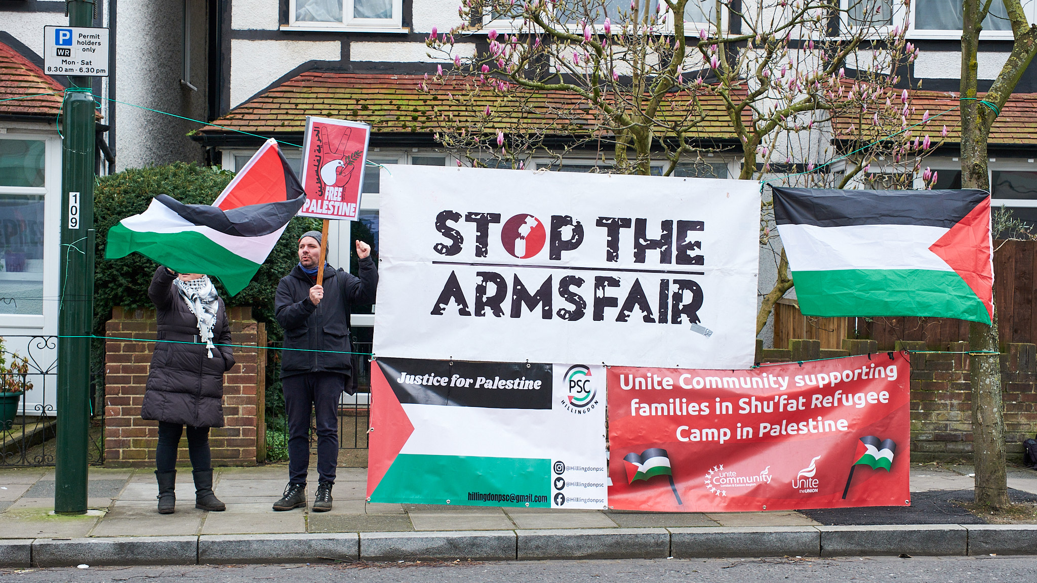 Signs and protesters opposite the stadium. (Photo Credit: Oliver Monk).