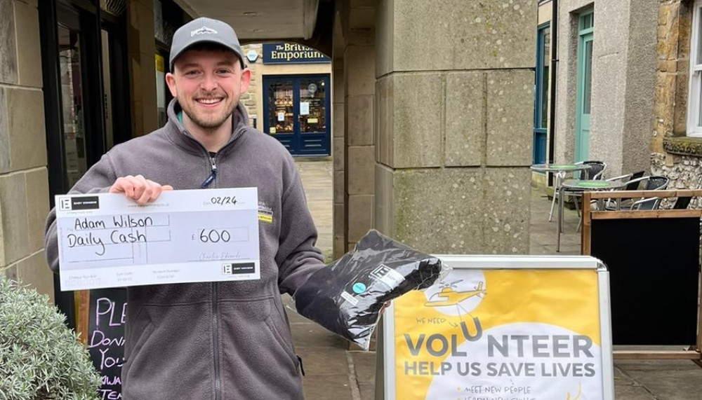 Adam Wilson is pleased as punch with his cash cheque and Easy Winning hoodie. (Image - Macclesfield Nub News)