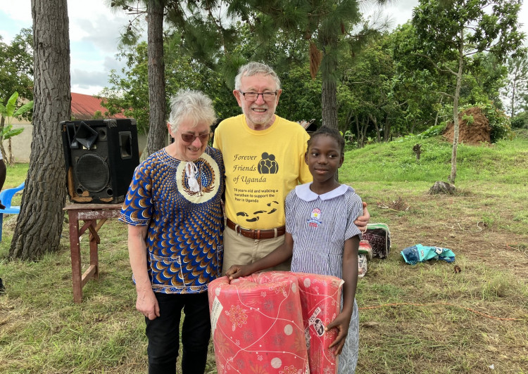 Stockport local Keith Mills has published his memoirs, a record of a massively varied life spanning a myriad of countries and occupations. He is pictured here with his wife Jeanette and a child who has benefited from the Forever Friends of Uganda project (Image - Keith Mills)