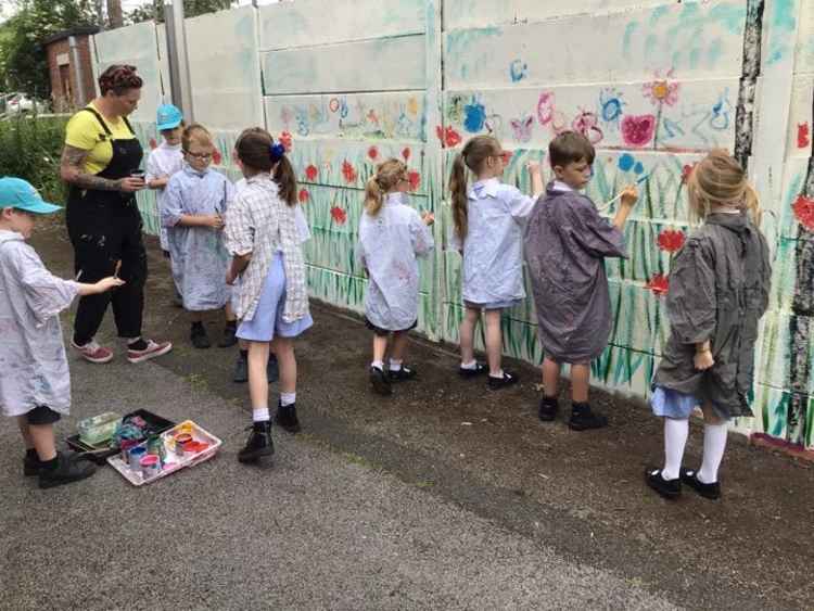 Kingsley St John's pupils work on their wildflower mural. Image courtesy of Kingsley St John's Primary School