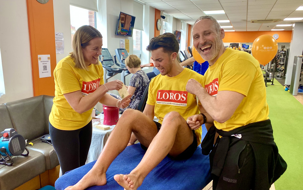 Fitness Republic owners Sarah and Simon Pellecchia tear off another painful strip during Connor's two hour leg waxing at the Ashby gym. Photo by Ashby Nub News