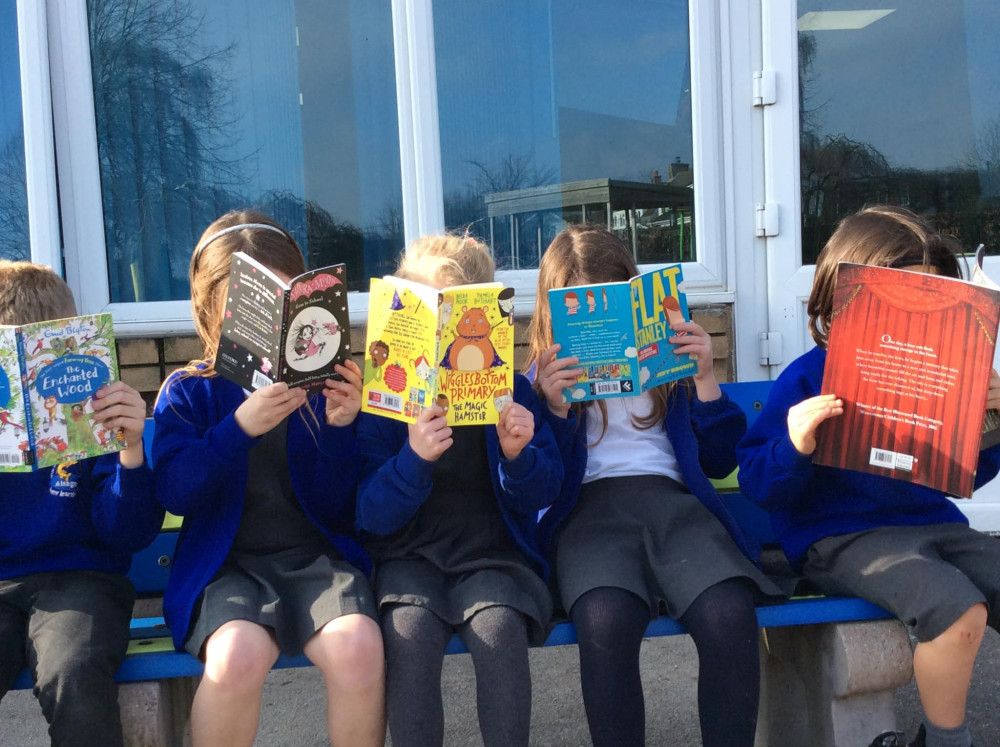 Children enjoying a delivery of new books at Pikemere School. (Photo: Pikemere PTA)