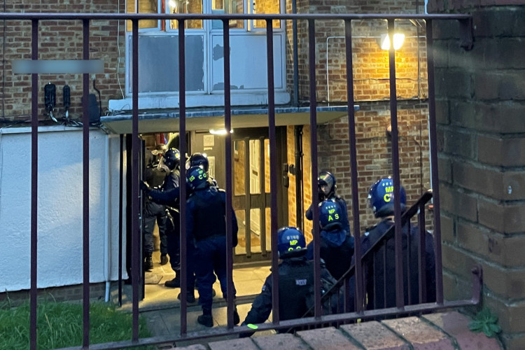 Met Police officers raid a home in Hillingdon of a man suspected to be dealing Class A drugs (credit: Met Police).