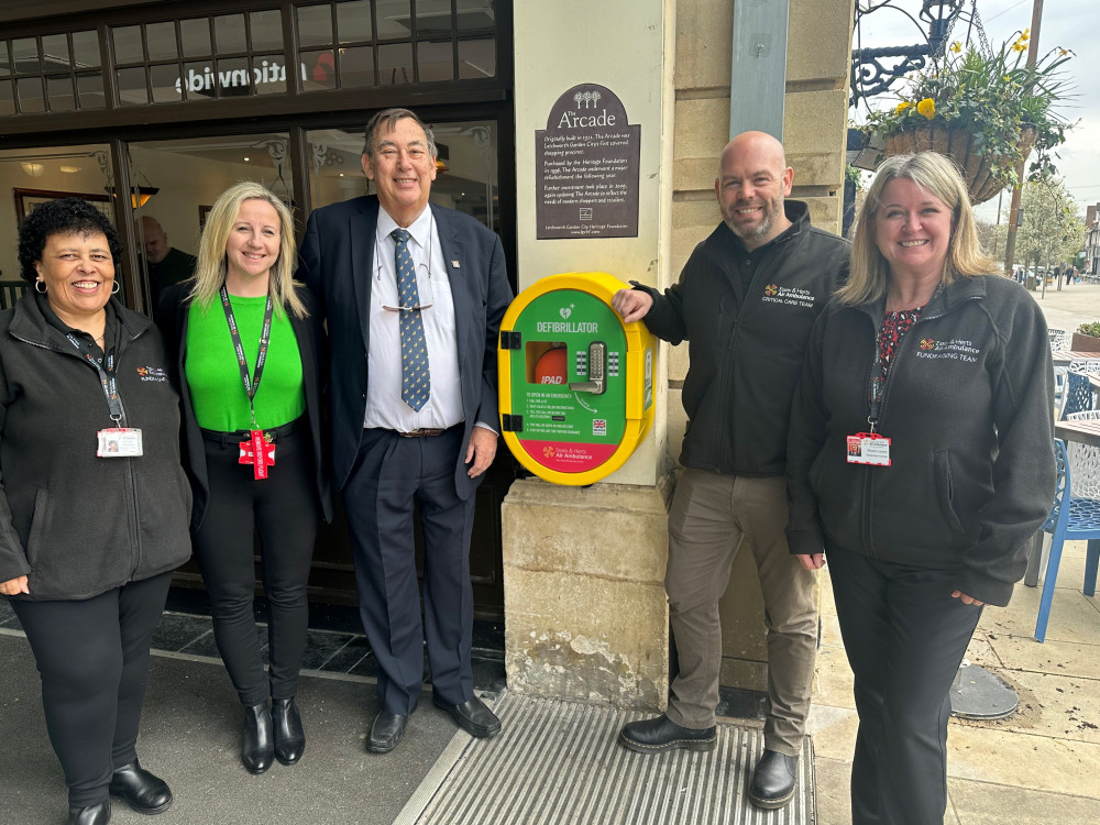 Yvonne Barnes, Leila Clarke, Cllr Terry Hone, Adam Carr and Sharon Lenton show the spot where the new defibrillator is situated