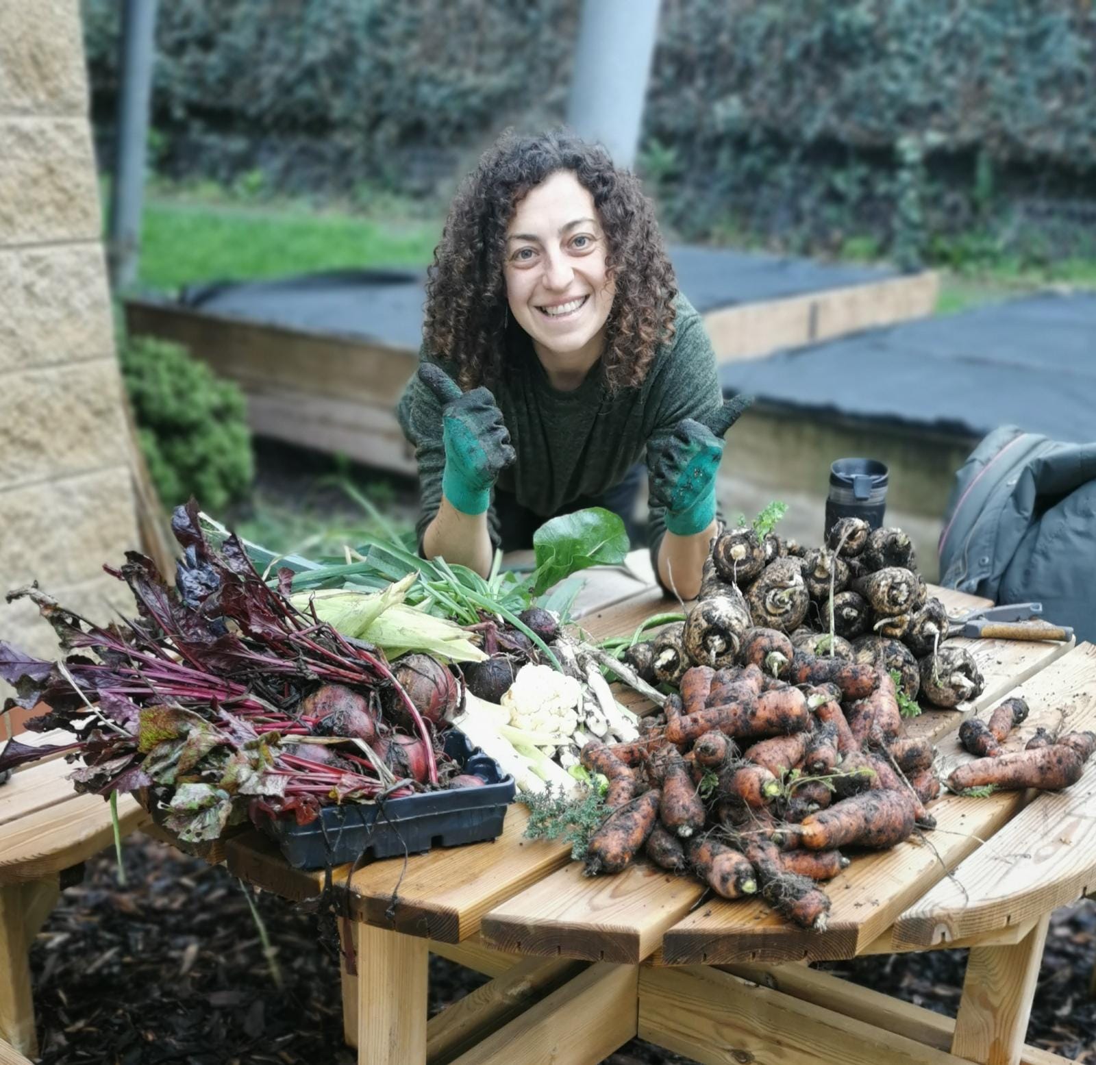 Charlotte Carson, Community Sustainability Lead at Frome Medical Practice, with produce grown in their home made compost