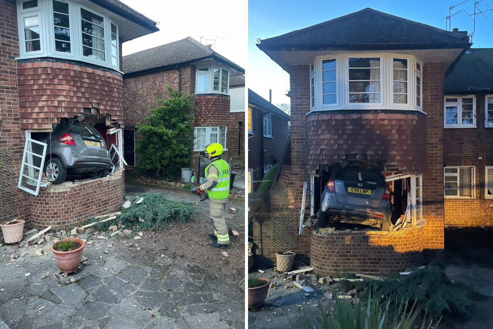 A firefighter attends a home in Twickenham after a car crashes into its front window (Photo: Catherine Blake)