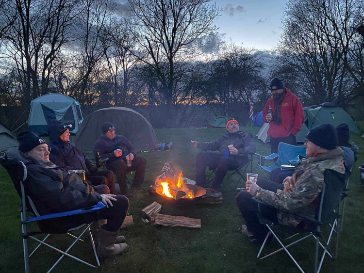 The team enjoying a BBQ ahead of their chilly night out in tents. Image credit: RAFBC. 