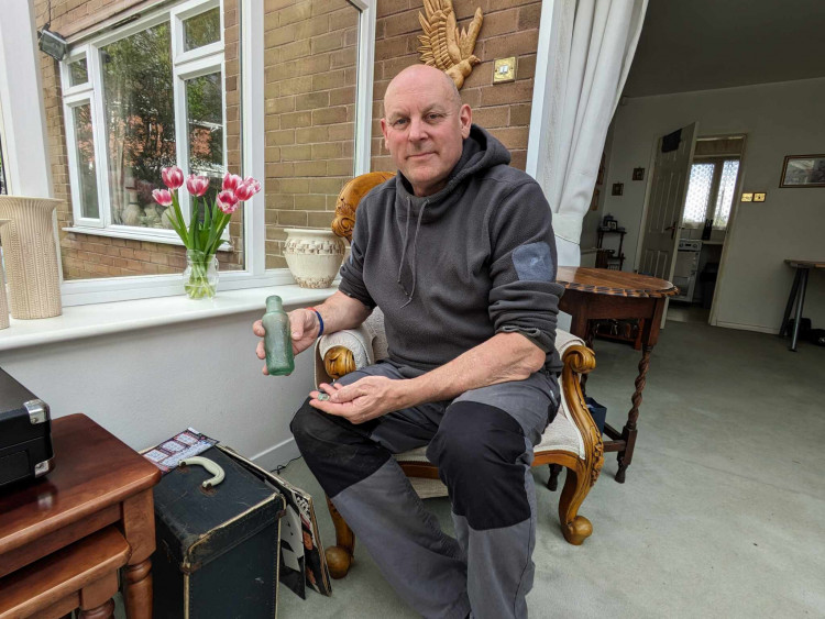 A Sandbach man wants to find out the history of the green bottle he found in a steam as a child. (Photo: Nub News)