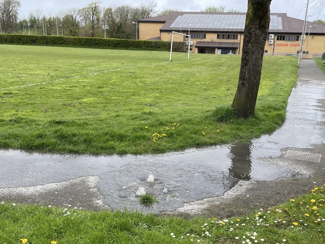 Raw sewage bubbles out over the pedestrian path