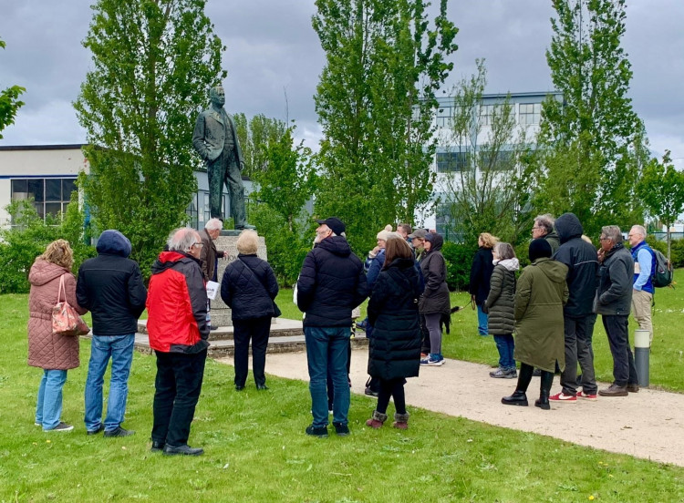 Visitiros look at the memorial to Tomáš Jan Baťa