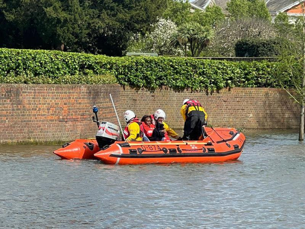 The walkers being pulled aboard a D-class lifeboat launched from Teddington's RNLI station (Photo: Teddington RNLI)