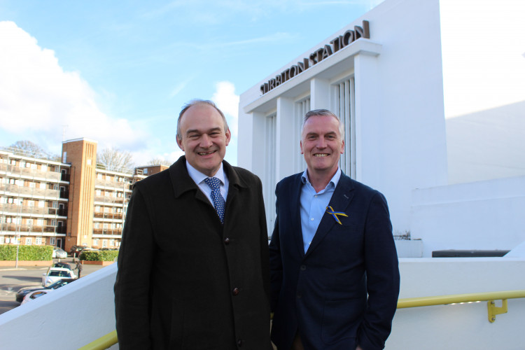 Lib Dem candidate for SW London's GLA seat Gareth Roberts (right) with party leader Ed Davey (left) outside Surbiton Station (Photo: Liberal Democrats)