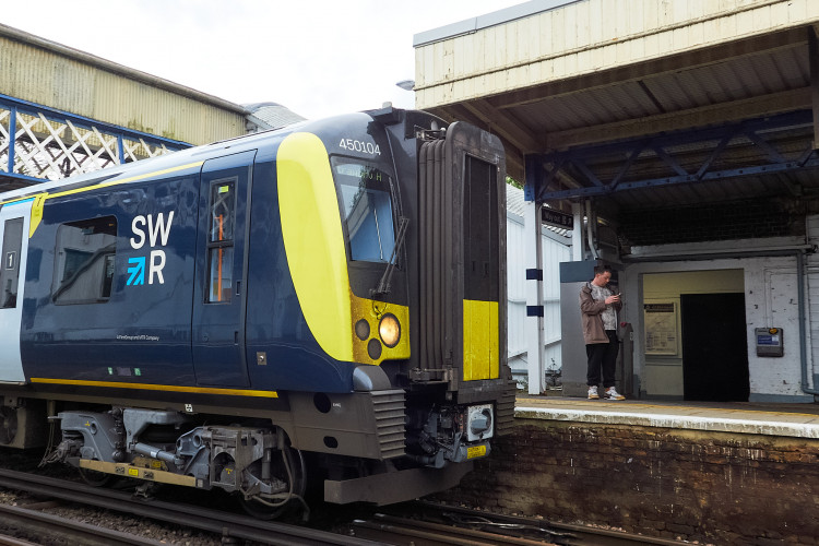 A person waits for a South Western Railway train to depart. (Photo: Oliver Monk)