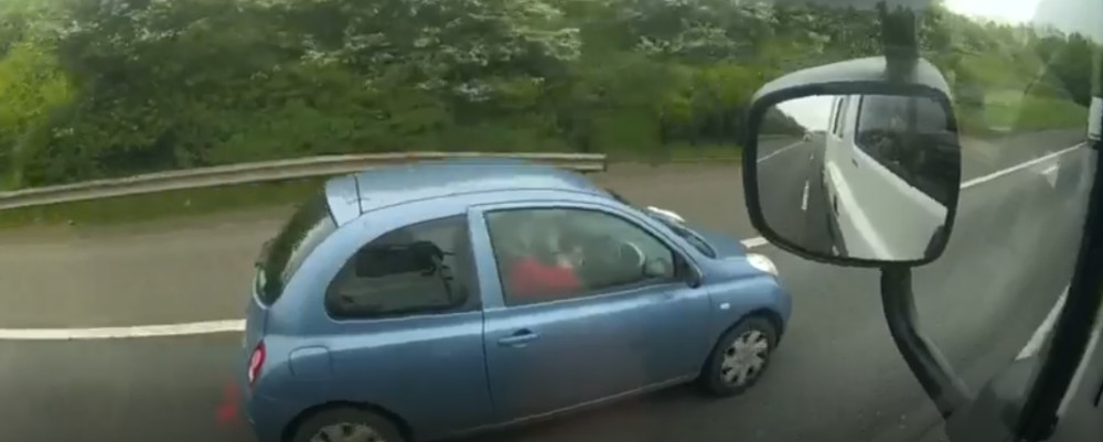 Watch the police footage of this driver putting on makeup at the wheel (image via Warwickshire Police)