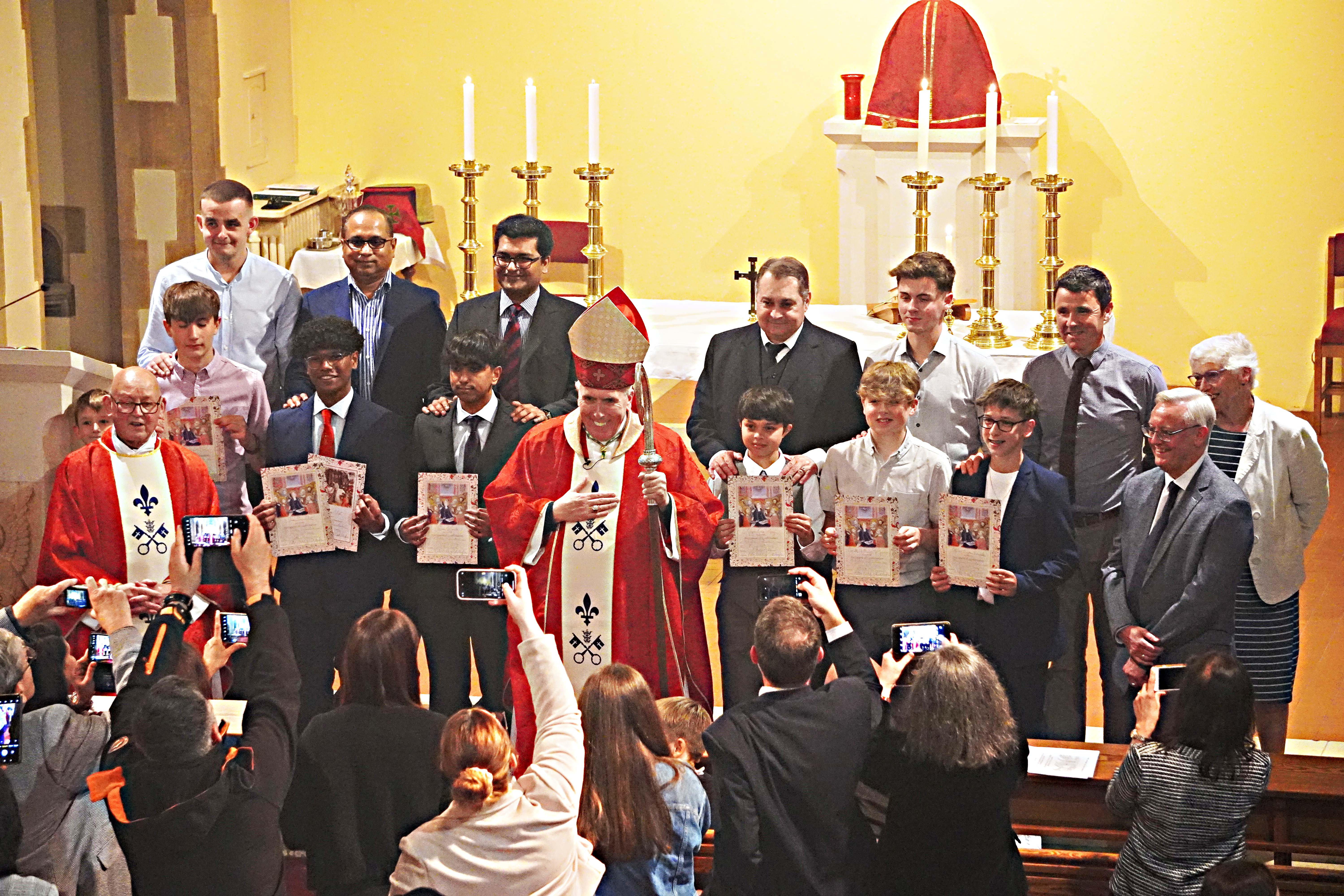 Confirmation candidates gather with relatives, the bishop and Canon John Barnes (Photo: Alan Lamberton and Wilf Ablard)