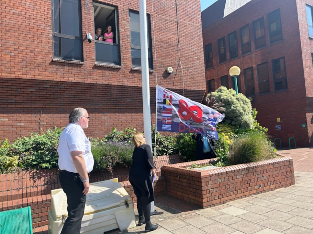 Mayor Cllr Kairen Raper raised the D-Day flag. 