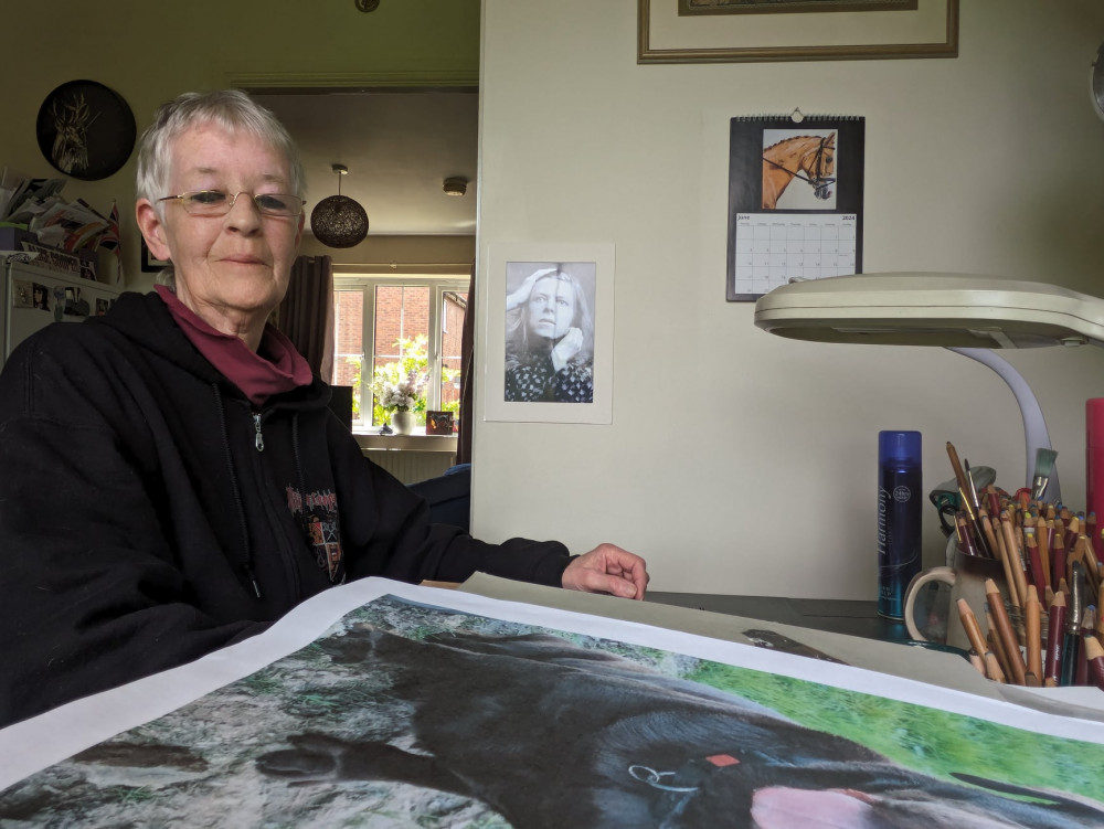 Julie works from her kitchen table, often listening to the music of the icons she's sketching. (Photo: Nub News)