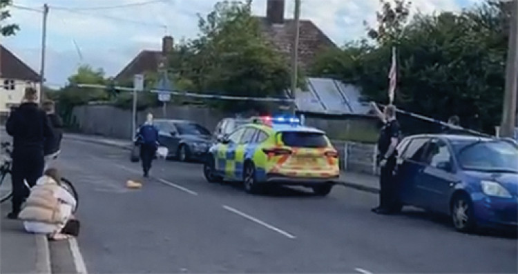 A police forensic officer enters the cordoned area. 