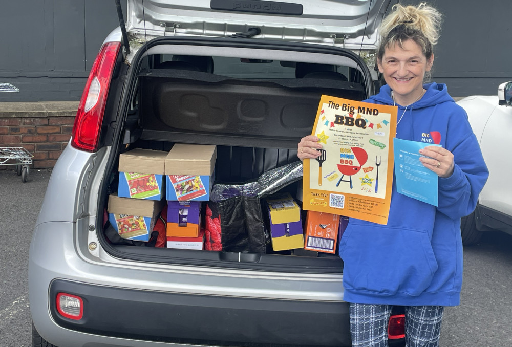 Karen Sivewright with a boot full of Co-op donations. 