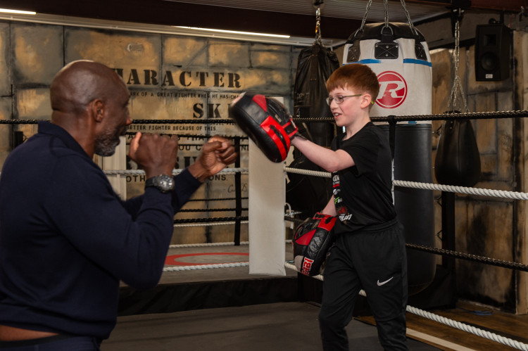 Former professional boxer and boxing pundit Johnny Nelson MBE spars with an aspiring young boxer at Clearys (image supplied)