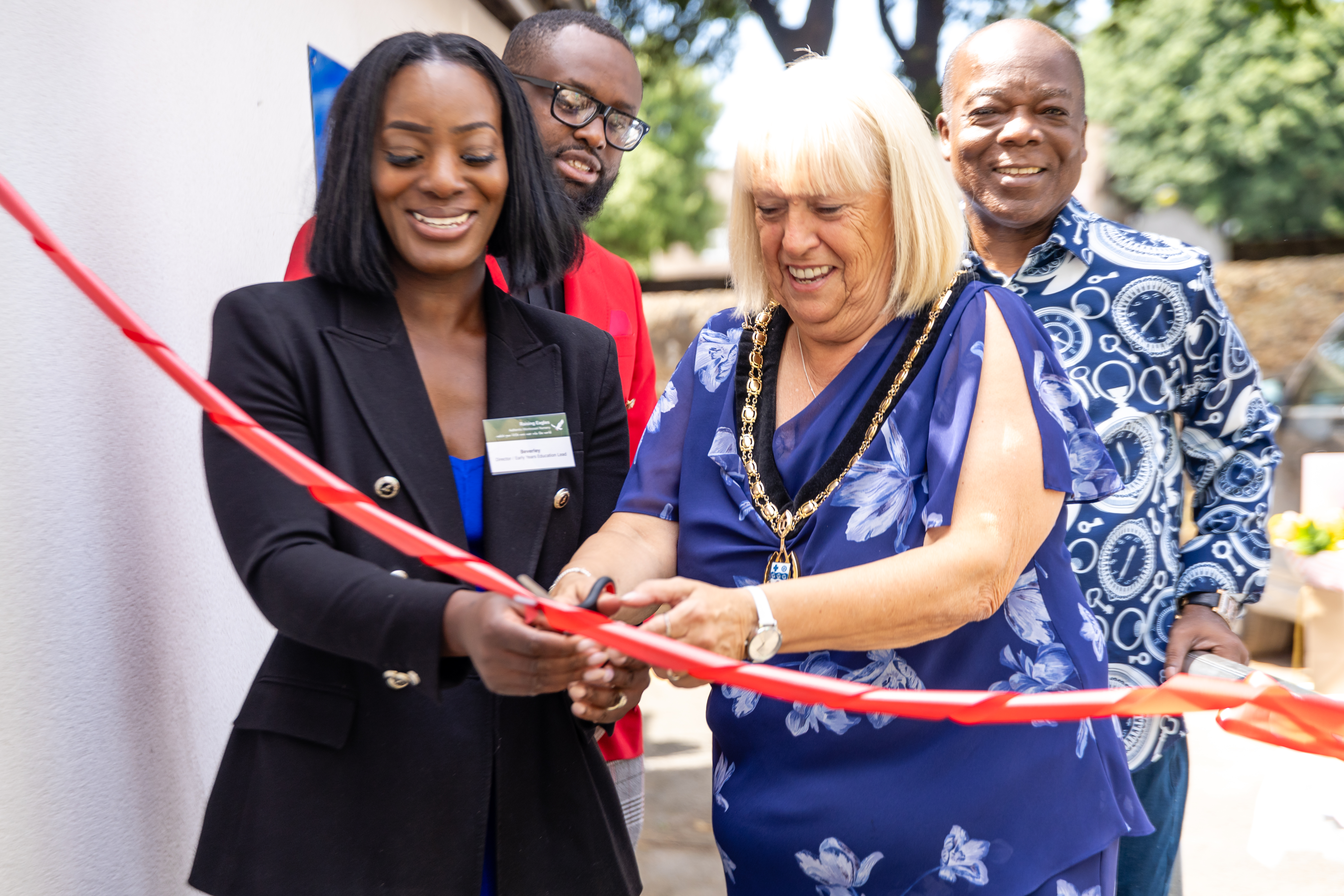 Deputy Mayor Cllr Sue Shinnick, Raising Eagles staff and CEO, Beverley Boateng at the ribbon cutting.