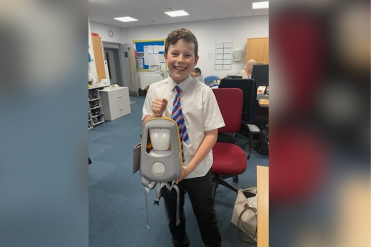 Howard Thomas holding the AV1 robot (credit: Momentum Children’s Charity).