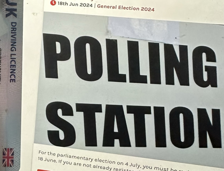 A driving licence, next to a sign for a polling station. (Image - Macclesfield Nub News) 