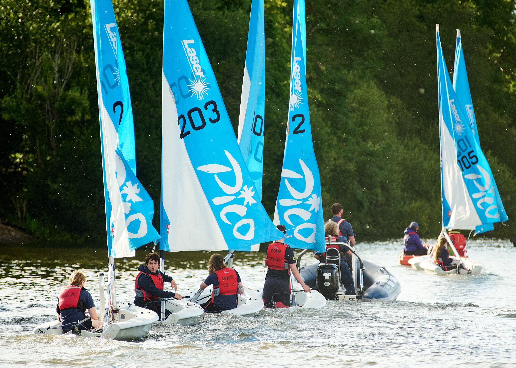 A group of small 'Pico' sailboats get a tow to the meeting point. (Photo: Oliver Monk)