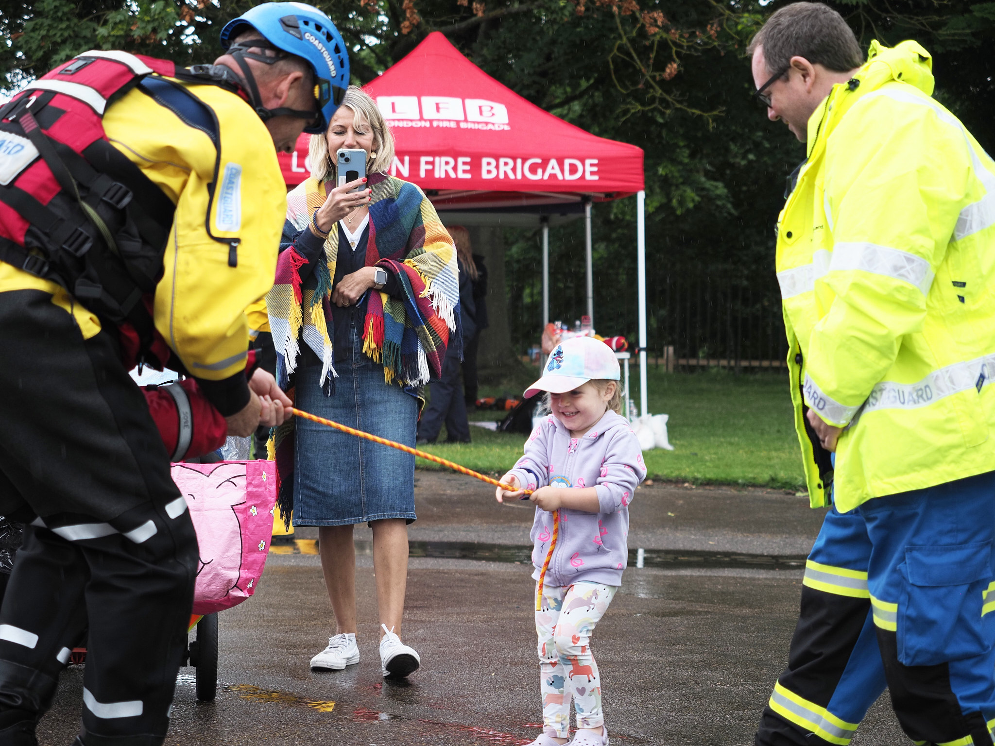 The weather doesn’t dissuade the younger volunteers from showing off their skills with the HM Coastguards’ life bags. (Photo: Oliver Monk)