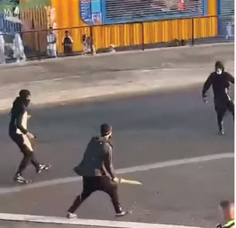 Machete and knife-wielding youths clashed on seafront - while in the background youngsters were enjoying all the fun of the fair!