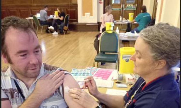 Sarah gives a vaccination to Cllr Mark Roberts, deputy leader of Stockport Council (Image via Stockport Council)