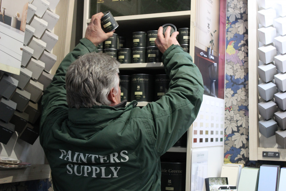 Mark Le Moignan stacks up stock at Painters Supply Limited, of Broken Cross, Macclesfield. (Image - Macclesfield Nub News) 