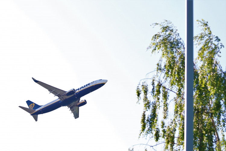 A Ryanair flight departs from Luton Airport on the Bedfordshire and Hertfordshire border