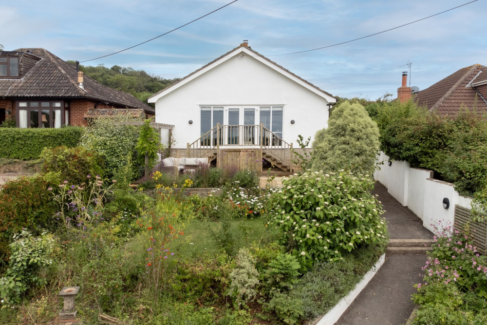 This well-presented three-bedroom bungalow in Wookey Hole boasts beautiful gardens, a converted outbuilding, and stunning countryside views, just a short drive from Wells.