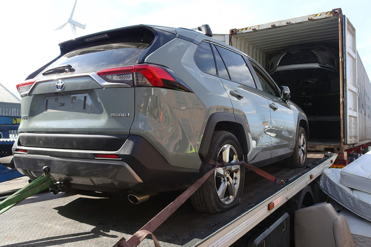 Recovered cars being unloaded from containers at Tilbury.