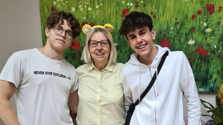 An Ealing homestay host (centre) alongside West London English School students (credit: West London English School).  