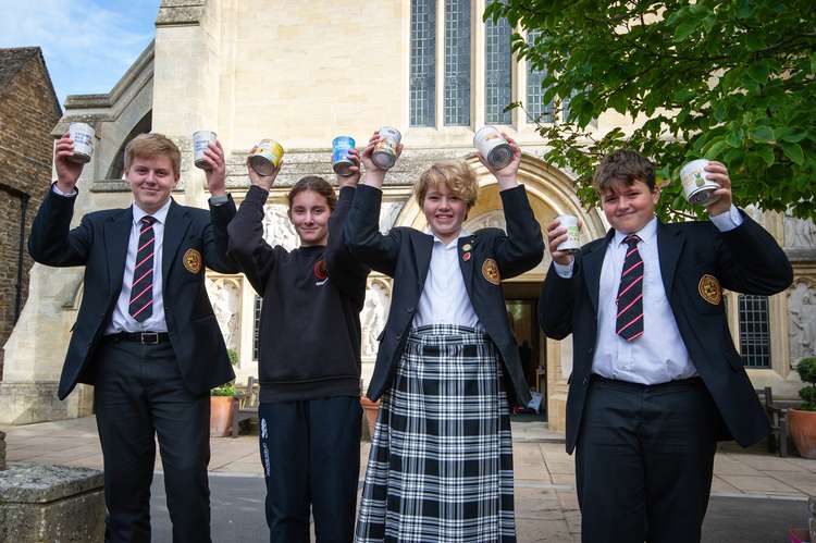 Pupils holding up their donations