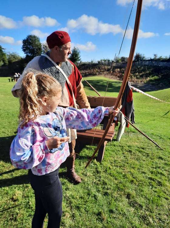 Bethany, aged 9, having a go at archery at the Oakham Castle fun day