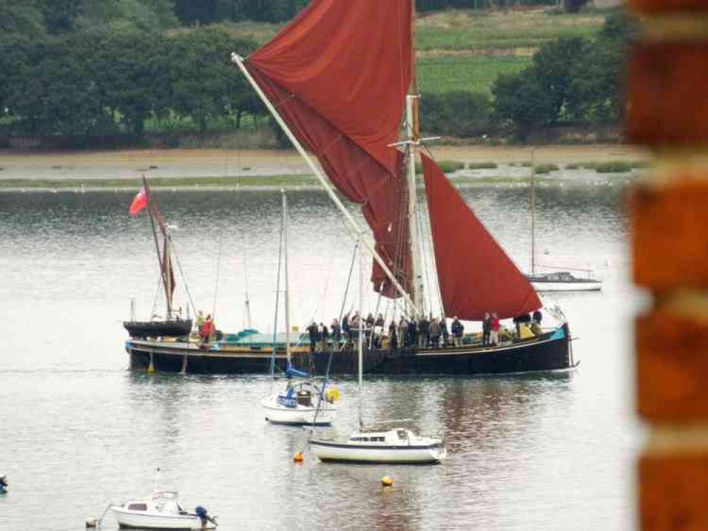 A Thames barge serenely sails by