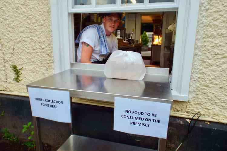 Dale Russell Butt & Oyster general manager serving at the takeaway hatch