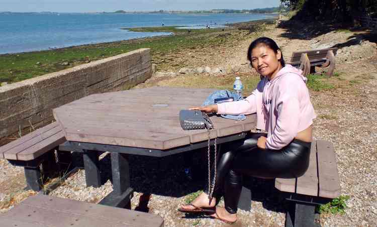 Lisa from Manchester with her friends collecting oysters in the background