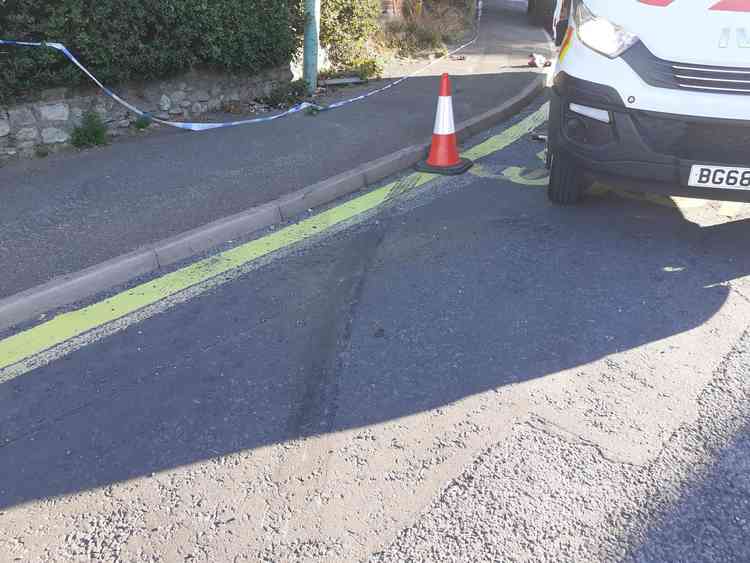 Skid marks and debris show evidence of collision