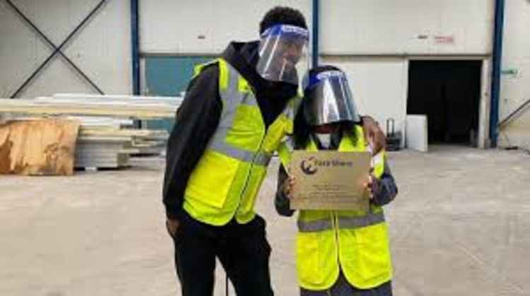 Marcus Rashford and his mum helping at a food bank