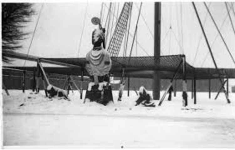 Snow covering figurehead at base of mast c1940