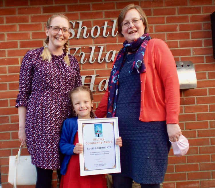 Louise Southgate presented with her award by young Emilee, with nominator Gemma Dennis