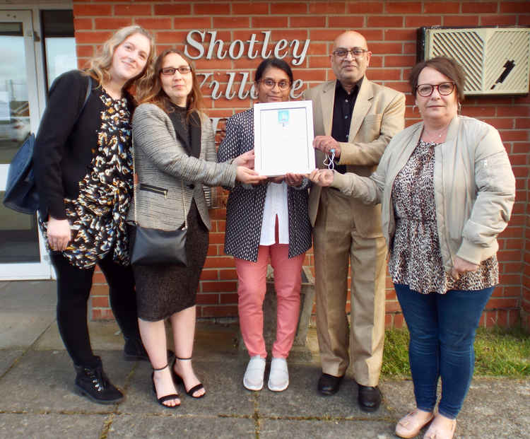 Manish and Trupti Patel with shop and post office staff