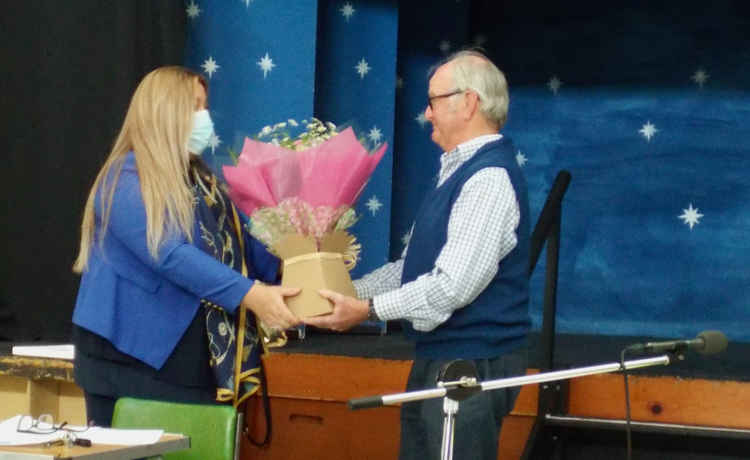 Clek Dina gets flowers from chairman