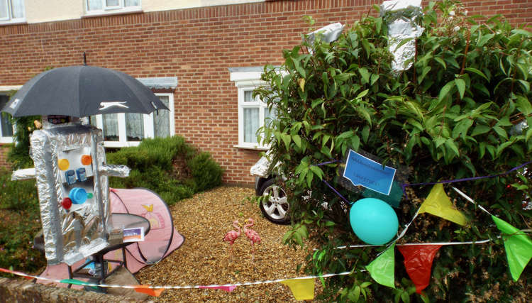 This robot has an umbrella to keep dry in Great Harlings