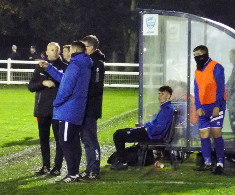 Imps under 18s manager Dan Hart deep in discussions with coaches Gary Pratt and Steve Nightingale